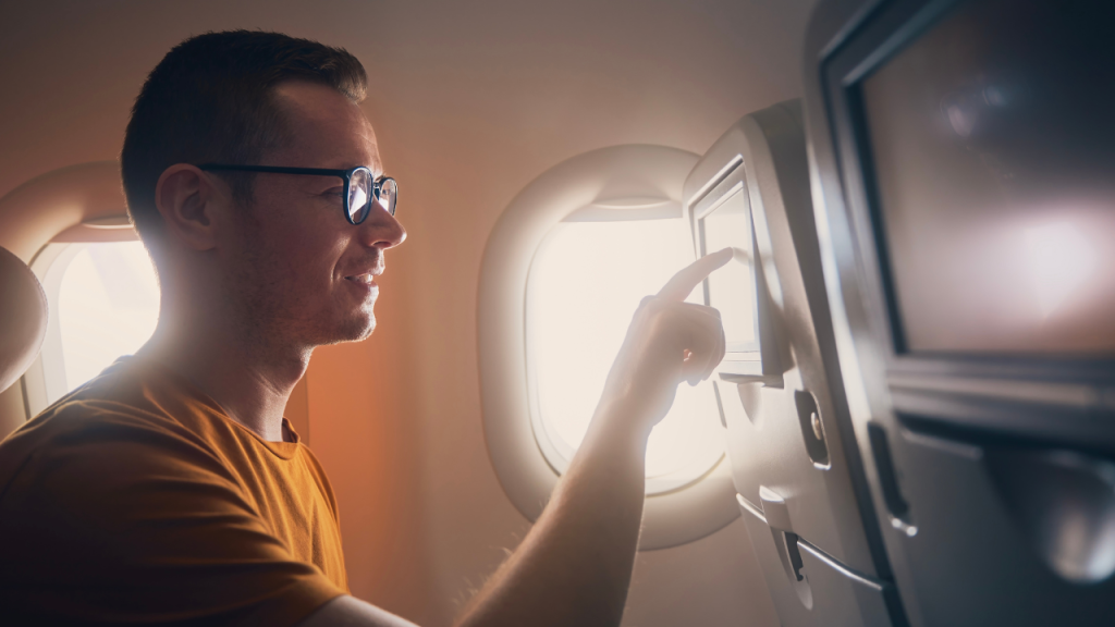 man on a plane using the touch screen